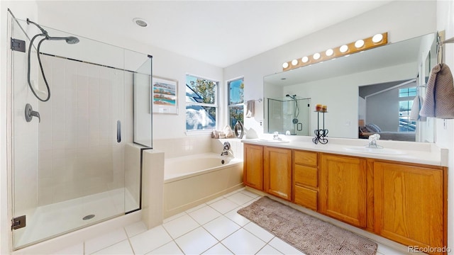 bathroom with tile patterned flooring, vanity, independent shower and bath, and a healthy amount of sunlight