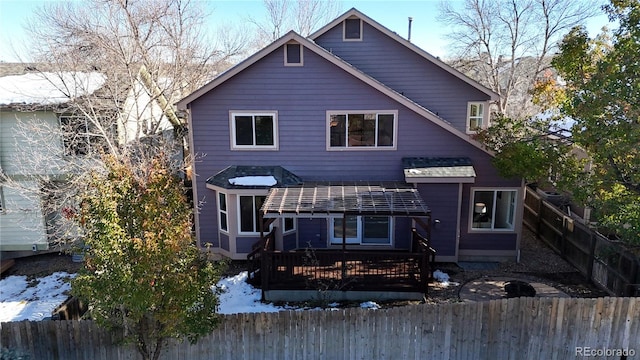 rear view of house featuring a deck