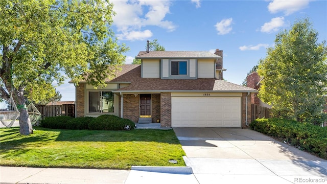 view of property featuring a garage and a front yard