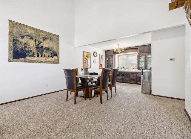 dining room with an inviting chandelier and carpet flooring