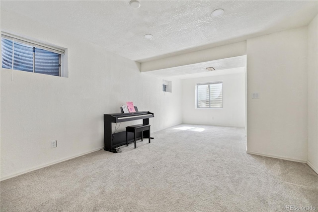 empty room with carpet and a textured ceiling