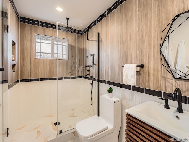 bathroom featuring tile walls, toilet, vanity, a shower stall, and backsplash