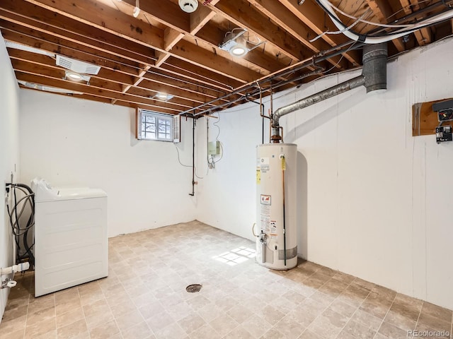 basement with water heater, washer / clothes dryer, and visible vents