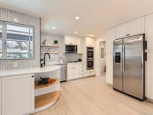 kitchen featuring white cabinetry, appliances with stainless steel finishes, open shelves, and decorative backsplash