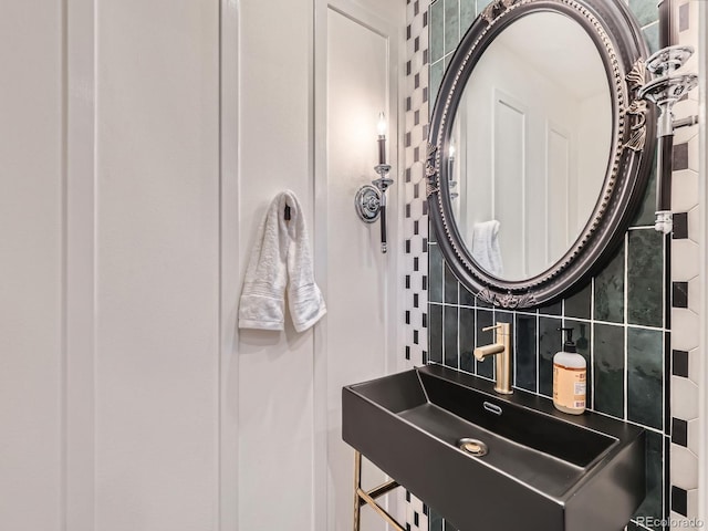 bathroom with tasteful backsplash and a sink