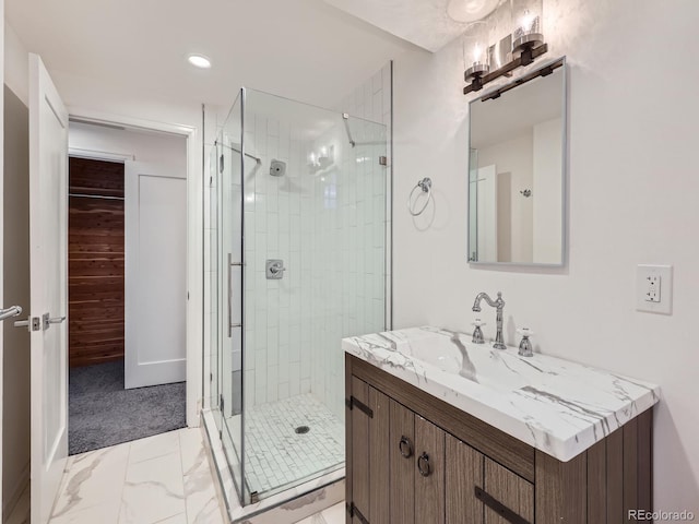 full bathroom with marble finish floor, a stall shower, vanity, and recessed lighting