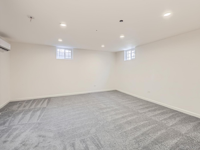 basement featuring recessed lighting, baseboards, carpet flooring, and a wall mounted AC