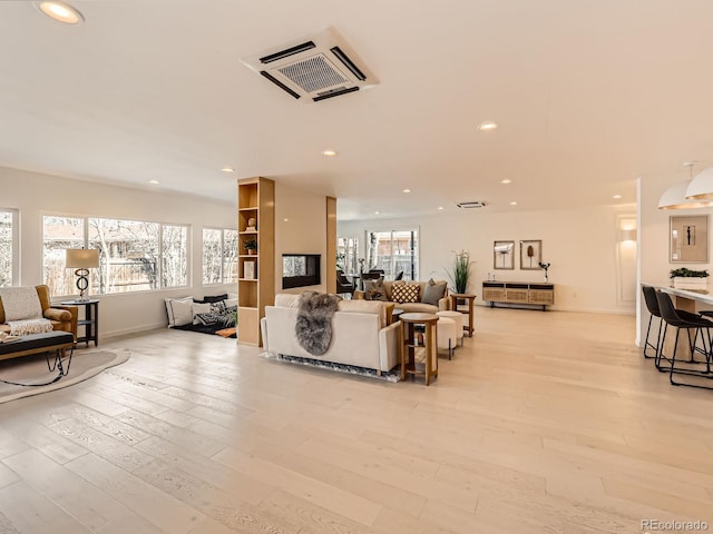 6585 E Nevada Pl, Denver, CO 80224 - living room with light wood-type flooring, baseboards, visible vents, and recessed lighting