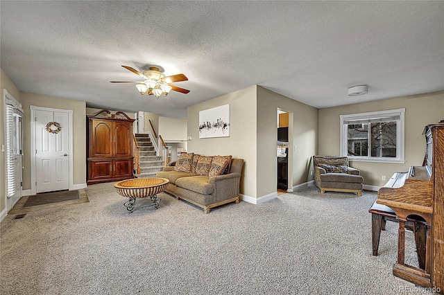 12028 W Aqueduct Dr, Littleton, CO 80127 - carpeted living area with baseboards, a textured ceiling, stairs, visible vents, and ceiling fan