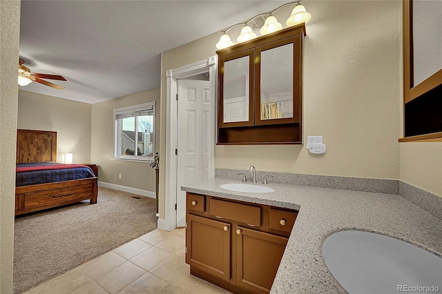 12028 W Aqueduct Dr, Littleton, CO 80127 - bathroom with tile patterned flooring, vanity, baseboards, and ceiling fan