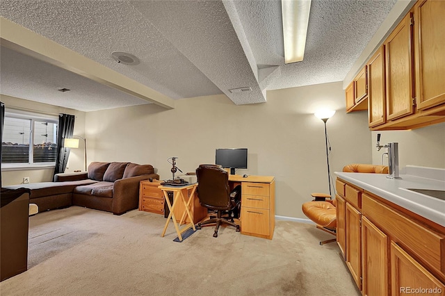 12028 W Aqueduct Dr, Littleton, CO 80127 - home office with visible vents, light colored carpet, and a textured ceiling
