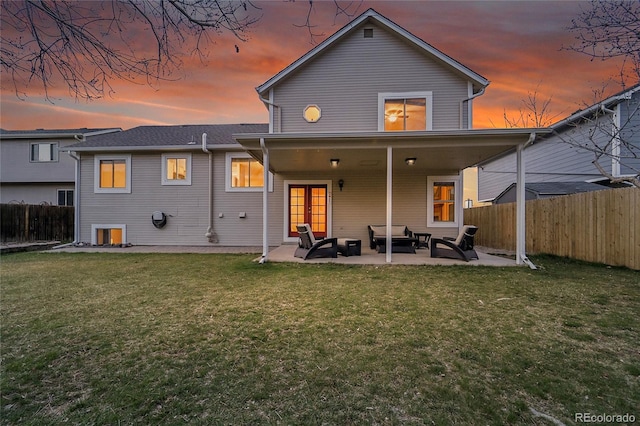 12028 W Aqueduct Dr, Littleton, CO 80127 - back of property with an outdoor living space, a patio area, a fenced backyard, and a lawn