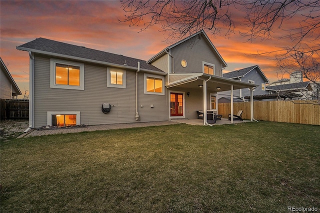 12028 W Aqueduct Dr, Littleton, CO 80127 - rear view of property featuring a patio area, a fenced backyard, and a yard