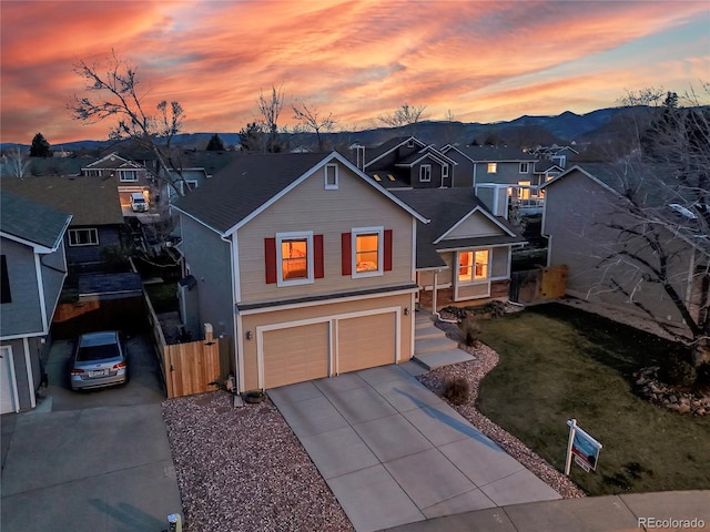 12028 W Aqueduct Dr, Littleton, CO 80127 - view of front of home with concrete driveway, a residential view, fence, and an attached garage