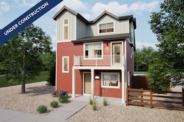 view of front of house featuring a balcony, fence, and board and batten siding