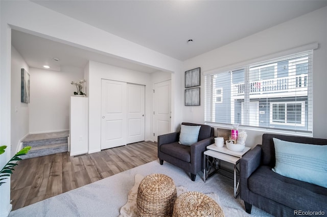 living area with wood finished floors and baseboards