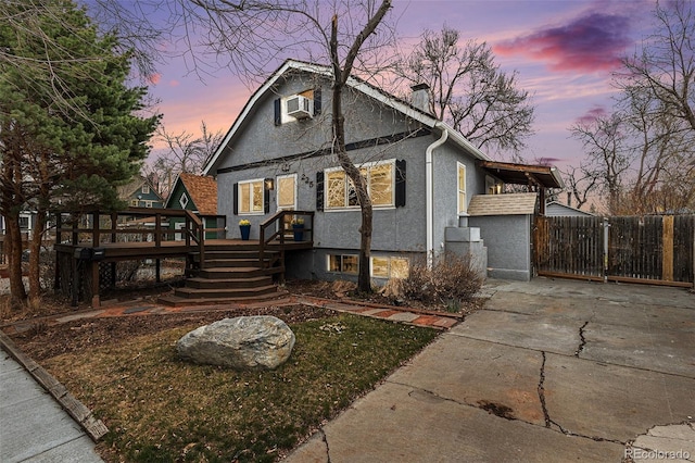 225 N Cedar St, Colorado Springs, CO 80903 - bungalow with concrete driveway, stucco siding, an AC wall unit, a chimney, and a gate