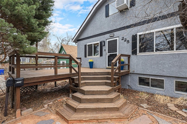 225 N Cedar St, Colorado Springs, CO 80903 - view of exterior entry featuring a wooden deck and stucco siding