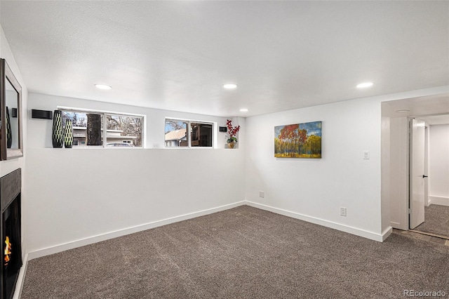 225 N Cedar St, Colorado Springs, CO 80903 - below grade area with a fireplace, carpet flooring, baseboards, and recessed lighting
