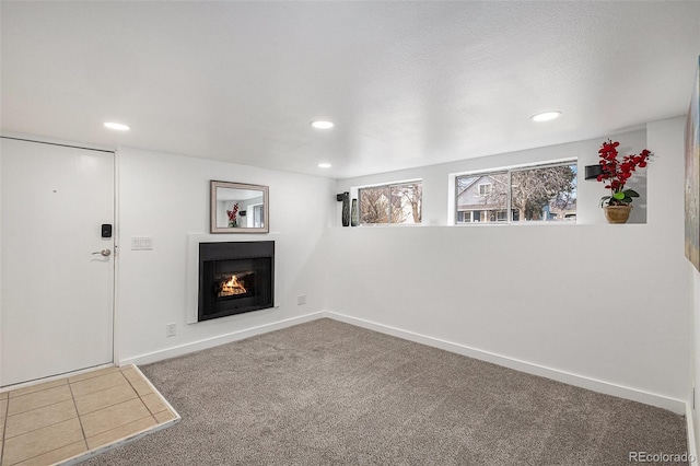 225 N Cedar St, Colorado Springs, CO 80903 - unfurnished living room featuring recessed lighting, carpet flooring, baseboards, and a warm lit fireplace