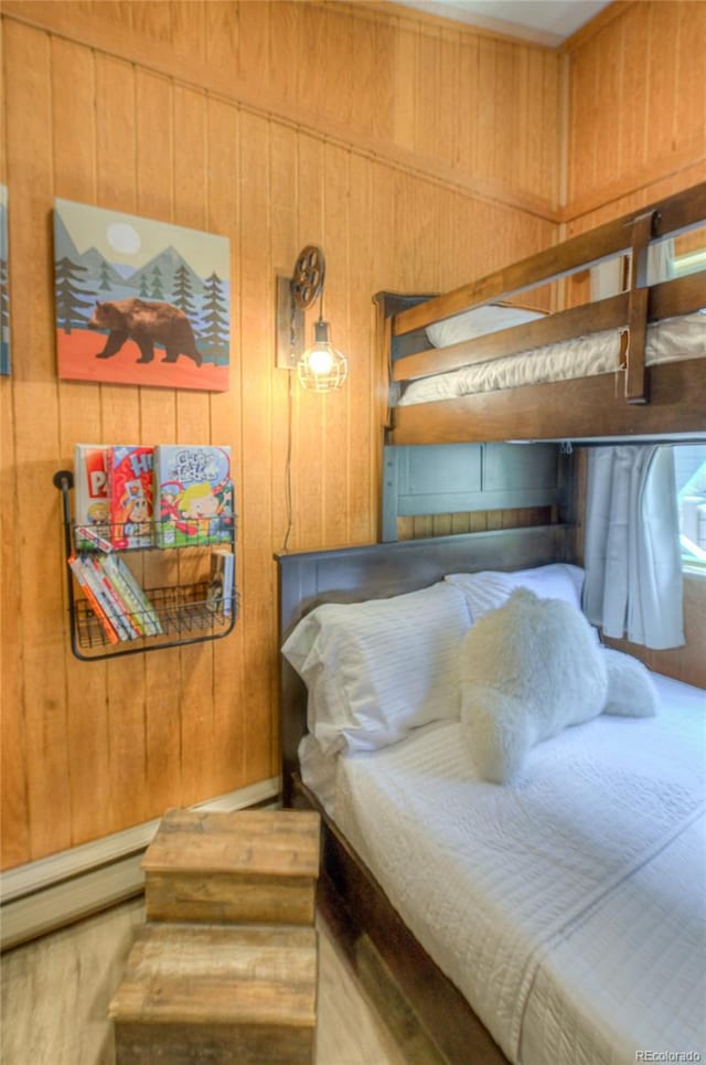 bedroom with wood walls