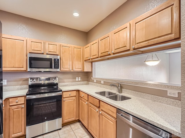 kitchen featuring sink, light tile patterned floors, light brown cabinets, and appliances with stainless steel finishes