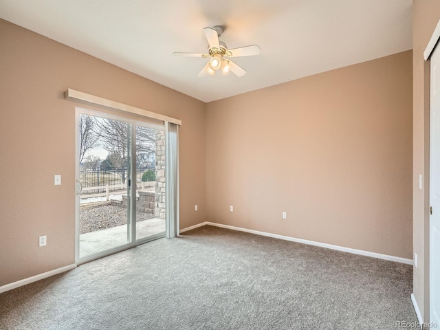 carpeted spare room featuring ceiling fan