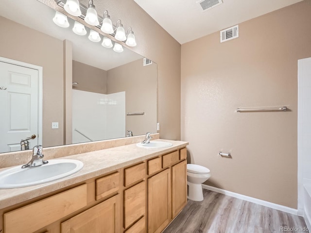 bathroom featuring vanity, hardwood / wood-style floors, and toilet