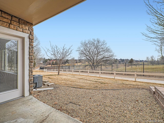 view of yard featuring a rural view and central air condition unit