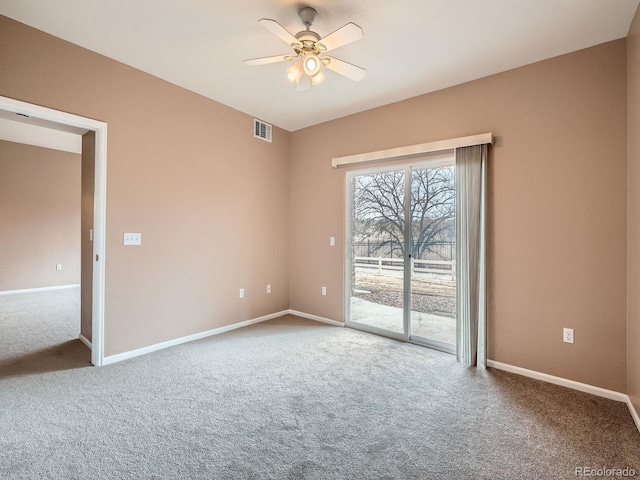 carpeted spare room featuring ceiling fan