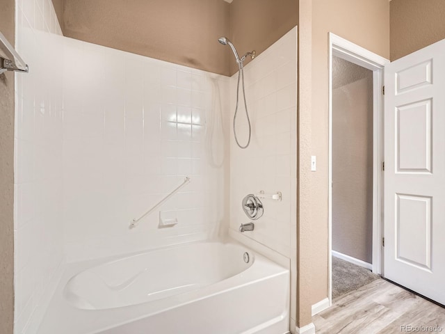 bathroom featuring bathing tub / shower combination and hardwood / wood-style floors