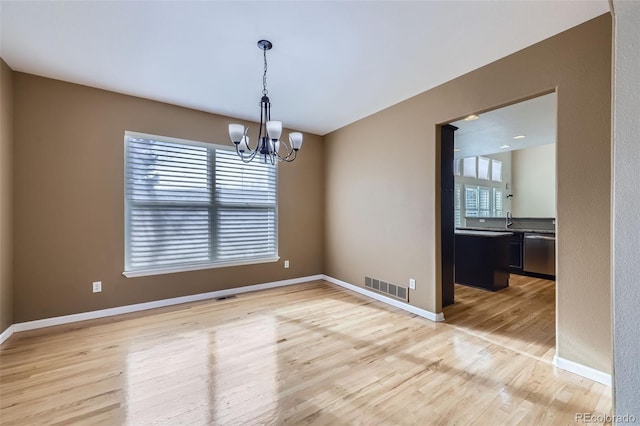 518 Zircon Way, Superior, CO 80027 - unfurnished room with light wood-style flooring, a chandelier, baseboards, and a sink