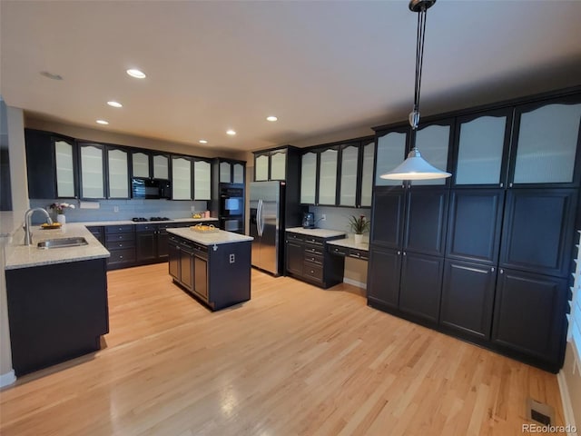 518 Zircon Way, Superior, CO 80027 - kitchen with black appliances, a sink, light wood-style floors, a center island, and glass insert cabinets