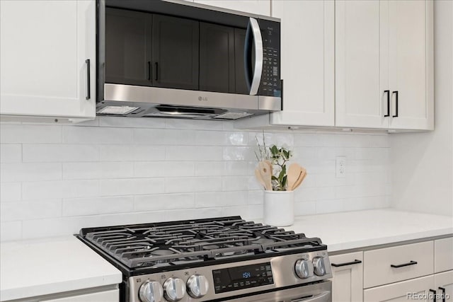 3413 W 114th Cir Unit B, Westminster, CO 80031 - kitchen featuring appliances with stainless steel finishes, light countertops, tasteful backsplash, and white cabinetry