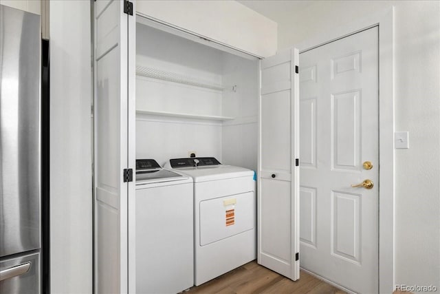 3413 W 114th Cir Unit B, Westminster, CO 80031 - washroom featuring separate washer and dryer and light wood-style flooring