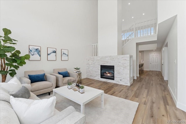 3413 W 114th Cir Unit B, Westminster, CO 80031 - living area with a high ceiling, light wood-type flooring, and a glass covered fireplace
