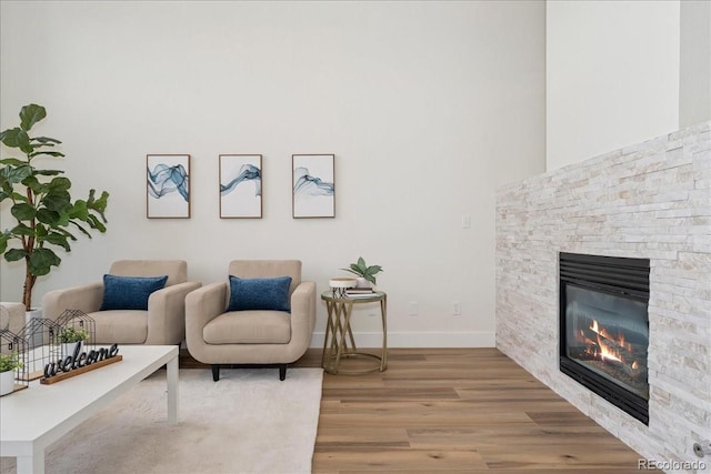 3413 W 114th Cir Unit B, Westminster, CO 80031 - living area with light wood-style floors and a stone fireplace