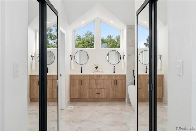 3413 W 114th Cir Unit B, Westminster, CO 80031 - full bathroom featuring double vanity, marble tiled flooring, and a soaking tub