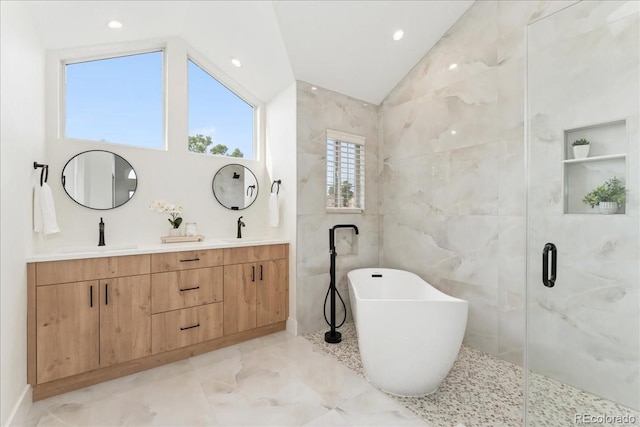 3413 W 114th Cir Unit B, Westminster, CO 80031 - bathroom featuring vaulted ceiling, a soaking tub, marble tiled floors, double vanity, and a shower stall