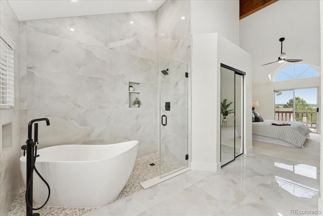 3413 W 114th Cir Unit B, Westminster, CO 80031 - ensuite bathroom with a freestanding bath, a stall shower, ceiling fan, marble tiled floors, and a high ceiling