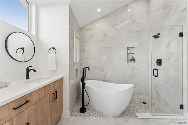 3413 W 114th Cir Unit B, Westminster, CO 80031 - bathroom with vanity, a soaking tub, a stall shower, and tile walls