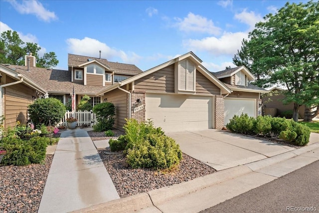 3413 W 114th Cir Unit B, Westminster, CO 80031 - view of front facade with brick siding, an attached garage, driveway, and a shingled roof