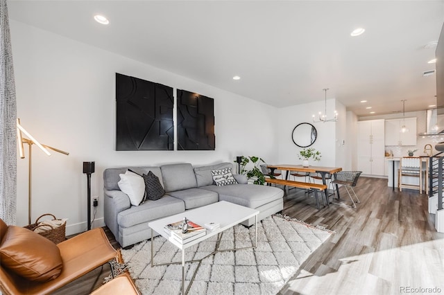 living room with a chandelier, recessed lighting, visible vents, and light wood-style flooring