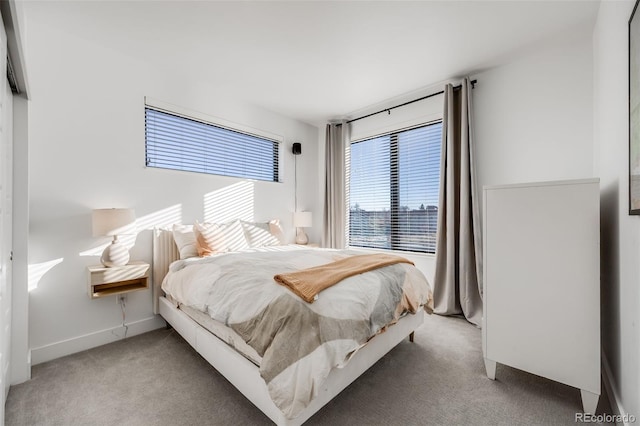 bedroom with carpet flooring and baseboards