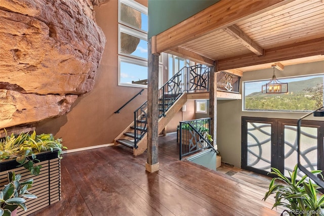 6619 Apache Pl, Larkspur, CO 80118 - stairway with hardwood / wood-style flooring, baseboards, and wooden ceiling with exposed beams