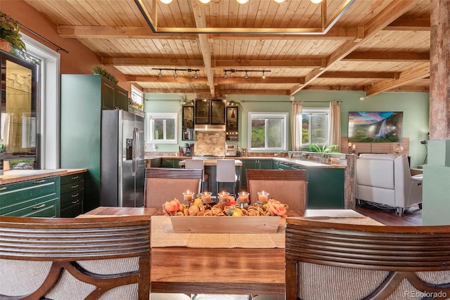 6619 Apache Pl, Larkspur, CO 80118 - kitchen featuring wooden ceiling with exposed beams, stainless steel fridge with ice dispenser, green cabinetry, wood finished floors, and track lighting