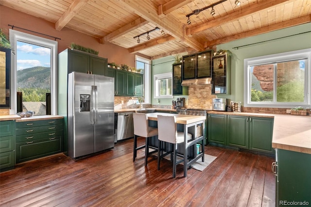 6619 Apache Pl, Larkspur, CO 80118 - kitchen featuring stainless steel appliances, green cabinetry, wood ceiling with exposed beams, light countertops, and dark wood finished floors