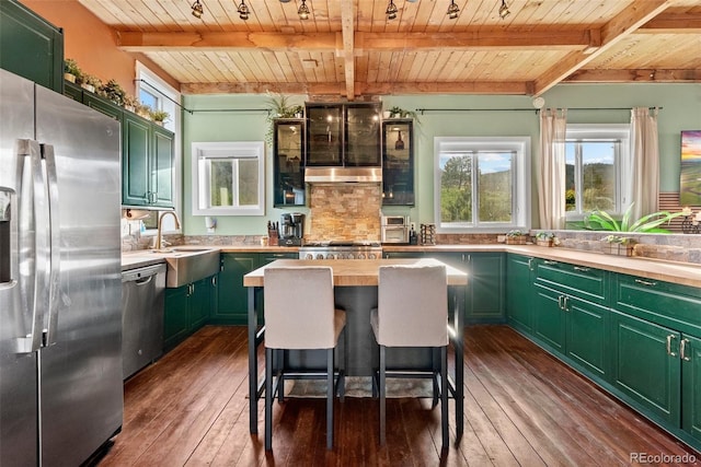6619 Apache Pl, Larkspur, CO 80118 - kitchen with appliances with stainless steel finishes, green cabinetry, wood ceiling with exposed beams, dark wood-type flooring, and tasteful backsplash