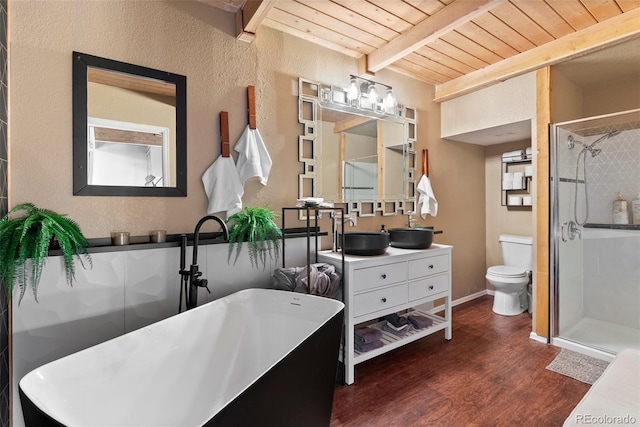 6619 Apache Pl, Larkspur, CO 80118 - full bathroom with wood ceiling with exposed beams, a stall shower, wood finished floors, vanity, and toilet
