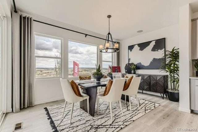 16947 W 92nd Dr, Arvada, CO 80007 - dining space with a chandelier, light wood-type flooring, and baseboards